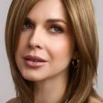 Blonde layered wig with side parting and natural waves.